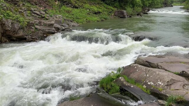Probiy waterfall on Prut River in Carpathians in overcast day