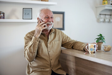 Home, phone call and senior man with conversation, communication and thinking with discussion. Apartment, elderly person and pensioner with a cellphone, relax and network with digital app and smile.