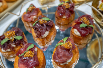 Gourmet Canapés with Cured Beef, Cream Cheese and Mustard Caviar on Toast Points
