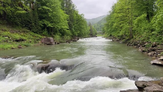 Probiy waterfall on Prut River in Carpathians in overcast day