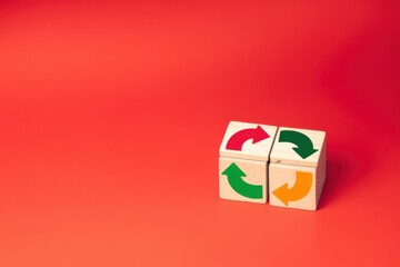 Three wooden blocks with arrows on a red background illustrating direction and choice