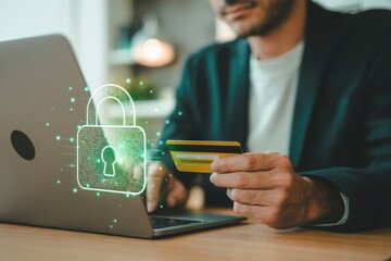 Man holding credit card and working on laptop with digital lock icon overlay