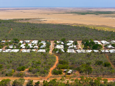 aerial view in Derby over bushland and housing towards marshland and the sea