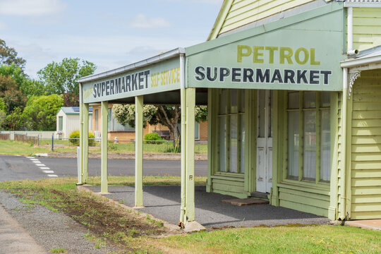 Street scene of an old small town supermarket with a wide veranda and posts over the footpath