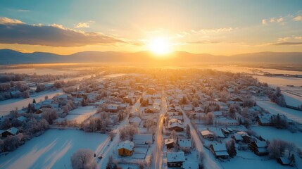 Winter village at sunset aerial view with golden hour