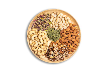 Assorted healthy nuts including almonds, cashews, walnuts, pistachios, macadamias, and pumpkin seeds on wooden plate. Organic superfood rich in protein, vitamins, and nutrition for clean eating.