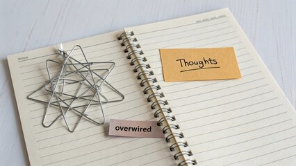 Geometric wire shapes and sticky notes on a spiral notebook