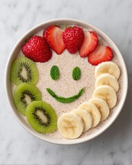 Healthy Snack for Children Colorful Fruit Bowl with Smile Design from Bananas, Strawberries, Kiwi, and Mint Colorful Children Food Ideas