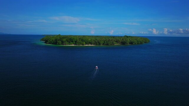 Fishing boat Yuo Island remote pristine untouched tropical coastline village Wewak Madang Cape Wom Papua New Guinea aerial drone PNG dry season summer morning blue sky static shot