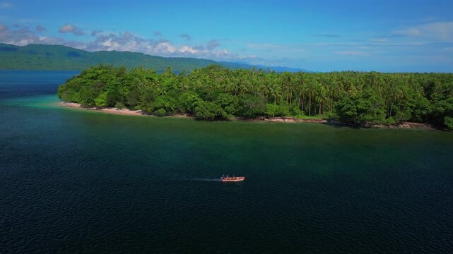 Fishing power boat Yuo Island beach shoreline remote pristine untouched tropical coastline village Wewak Madang Cape Wom Papua New Guinea aerial drone PNG East Sepik Province summer morning blue sky