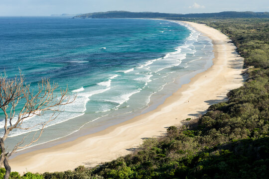 Long curve of sand and surf at Tallows Beach near Byron Bay