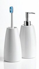White ceramic toothbrush holder and soap dispenser on a bright white background