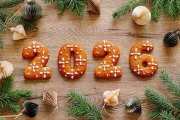 Festive 2026 Number Cookies On Wooden Table With Christmas Ornaments And Evergreen Branches