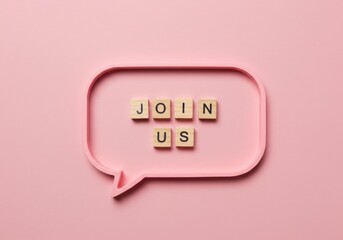 Speech bubble with wooden letters spelling join us on a pastel pink background