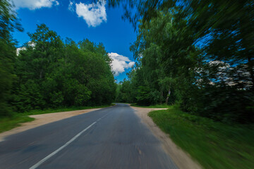 The effect of speed on the road and blur. View of the road on a summer day.