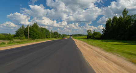 The effect of speed on the road and blur. View of the road on a summer day.