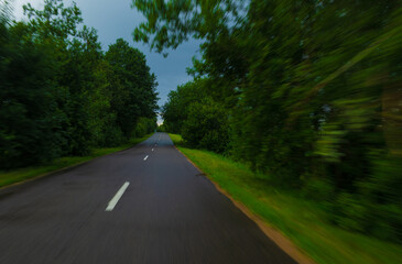 Obraz premium Road view on a summer day. Highways and bridge, roadside and white road line markings.