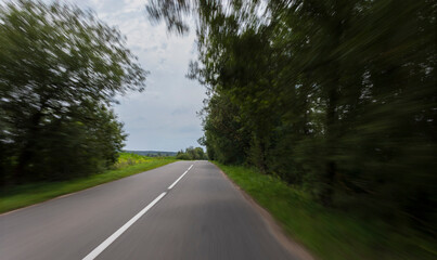 Fototapeta premium The effect of speed on the road and blur. View of the road on a summer day.