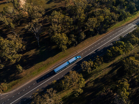 Semi-trailer truck travelling down Newell Highway road in Dubbo seen from aerial view