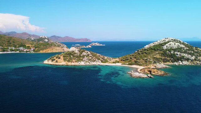 Aerial footage capturing the coastal scenery on the way to the historic Knidos Ancient City in Dat&ccedil;a, Turkey. Featuring picturesque rocky islands, crystal clear turquoise waters of the Aegean Sea, and