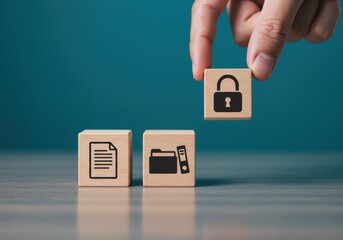 Hand placing wooden block with lock icon beside document and folder symbols on table