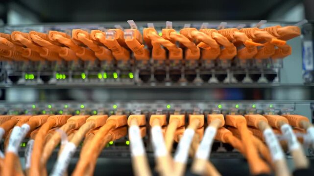 Illuminated Network Server Rack with Tangled Orange Ethernet Cables