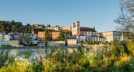 Passau, Bavaria, Germany: evening light on the old town and the St. Michael church accross the Inn river 