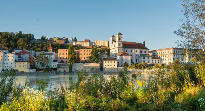 Passau, Bavaria, Germany: evening light on the old town and the St. Michael church accross the Inn river 