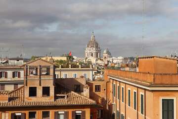 This view from the Spanish Steps highlights the rooftops of Rome's historic center and the dome of St. Peter's Basilica.