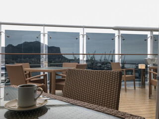 Guest pooldeck or swimmingpool with sun deck on modern family cruiseship or cruise ship liner with elegant lounge furniture deck chairs and rattan sun beds loungers