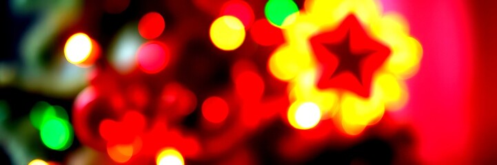 Obraz premium Bright holiday lights create a festive atmosphere around a decorated Christmas tree during the winter season - High Contrast