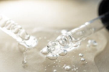 samples serum tests glass pipettes with drops of serum on a light beige background
