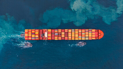 Aerial top view of cargo ships in containers sailing in the sea.
