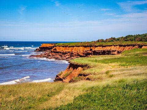 Rugged red cliff coast in Prince Edward Island National Park on the north shore of Prince Edward Island Canada