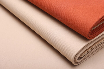 Top down close-up view of soft cashmere wool coating fabric in warm beige and terracotta color perfect for autumn fashion, fall textures, and seasonal textile design. 