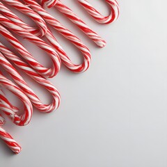 Red and White Striped Candy Canes Arranged Diagonally on a Minimalist Background