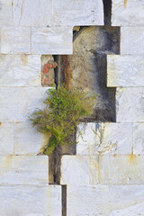 STONE BLOCKS DETACHED FROM THE SUPPORT - OLD CRACKED AND DAMAGED LIMESTONE STONE WALL cause due to subsidence, foundations structural failures or earthquake shocks