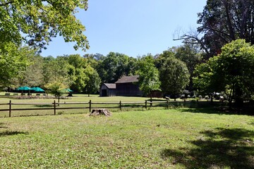 The old wood barn in the country on a sunny day.