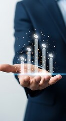 Businessperson's hand displaying a glowing digital growth chart representing financial success and forward progress in technology