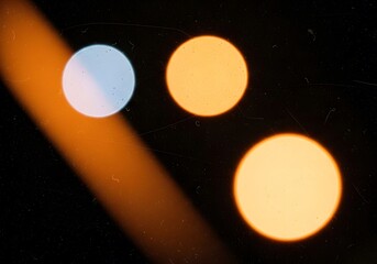 A Symphony of Bokeh, Light Leaks, and Grainy Textures in a Dark Abstract Composition with Amber, Orange, and Pale Blue Celestial Orbs Ascending in a Vintage Haze.