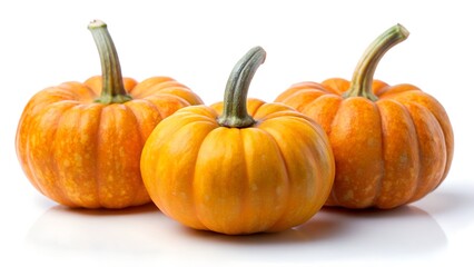 Obraz premium Three small pumpkins isolated on white background
