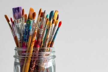 Paint brushes in a glass jar, art supplies, creative tools for painter