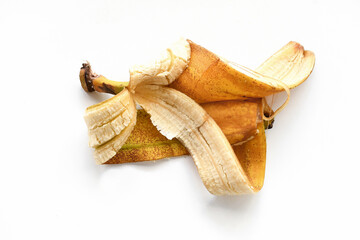 Rotten banana peel on white table. Photo can be used for the concept of the benefits of banana peel.