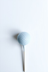 A Golf Ball On A Tee On A White Background