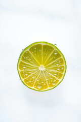 A Green Lime With Drops Of Water On A White Background