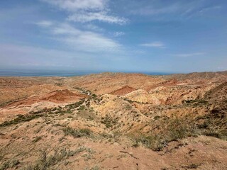 Rock formations in Skazka canyon, Kyrgyzstan looking out to Issyk Kul