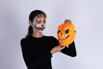Woman in black shirt holding Halloween mask