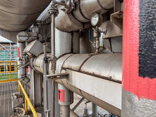 Complex industrial piping system conveys modern manufacturing infrastructure and technology.