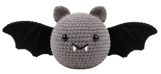 a cute, handmade grey bat doll with wings and fangs made of crocheted wool.