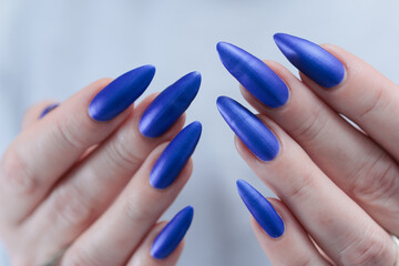beautiful hand with long nails and blue manicure